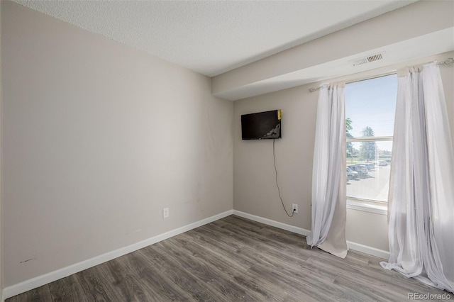 8843 Colorado Blvd Unit 208, Thornton, CO 80229 - empty room with wood finished floors and a textured ceiling