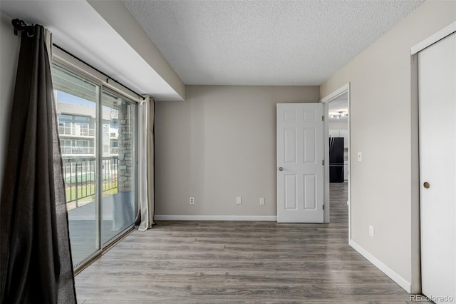 8843 Colorado Blvd Unit 208, Thornton, CO 80229 - empty room with a textured ceiling and wood finished floors