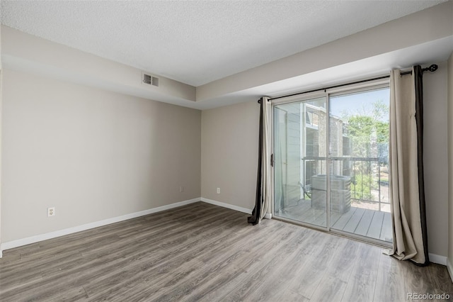 8843 Colorado Blvd Unit 208, Thornton, CO 80229 - spare room featuring wood finished floors and a textured ceiling