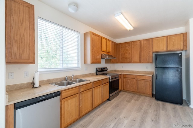 24664 E Louisiana Cir, Aurora, CO 80018 - kitchen featuring appliances with stainless steel finishes, exhaust hood, a sink, light wood-style floors, and light countertops