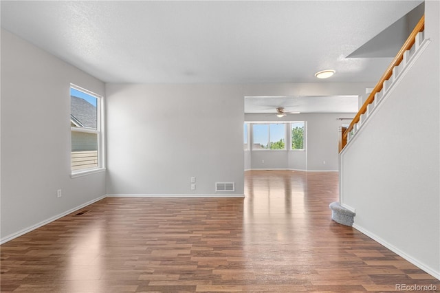 9638 Marion Way, Thornton, CO 80229 - unfurnished living room with wood finished floors, baseboards, and ceiling fan