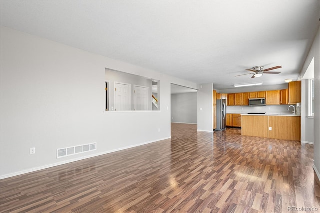 9638 Marion Way, Thornton, CO 80229 - unfurnished living room featuring dark wood-style floors, a sink, ceiling fan, and baseboards