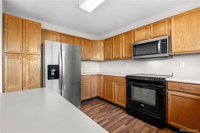 9638 Marion Way, Thornton, CO 80229 - kitchen featuring stainless steel appliances, dark wood-style flooring, light countertops, brown cabinetry, and a textured ceiling