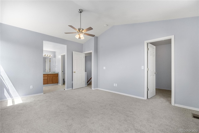 9638 Marion Way, Thornton, CO 80229 - unfurnished bedroom with light carpet, vaulted ceiling, baseboards, a spacious closet, and ensuite bath