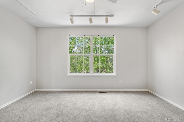 9638 Marion Way, Thornton, CO 80229 - spare room with track lighting, carpet floors, baseboards, and ceiling fan