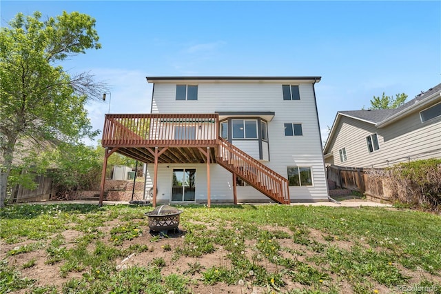 9638 Marion Way, Thornton, CO 80229 - back of house with a wooden deck, an outdoor fire pit, a fenced backyard, and stairs
