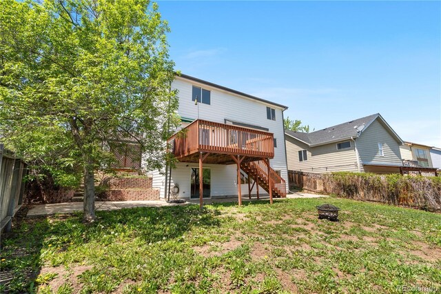 9638 Marion Way, Thornton, CO 80229 - rear view of house featuring stairway, a fire pit, a deck, a fenced backyard, and a patio