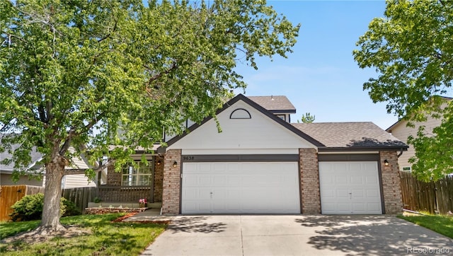 9638 Marion Way, Thornton, CO 80229 - view of front of property with an attached garage, brick siding, concrete driveway, fence, and roof with shingles