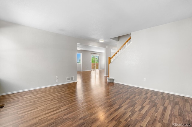 9638 Marion Way, Thornton, CO 80229 - unfurnished living room featuring wood finished floors, baseboards, and stairs