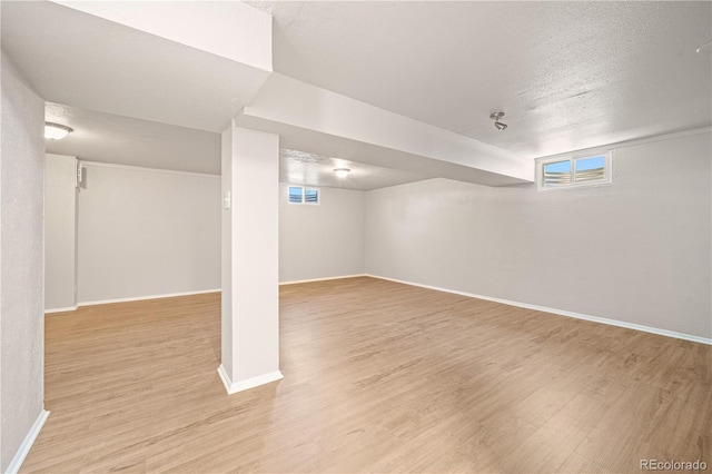 2925 Azalea St, Pueblo, CO 81005 - below grade area with light wood-style flooring and a textured ceiling