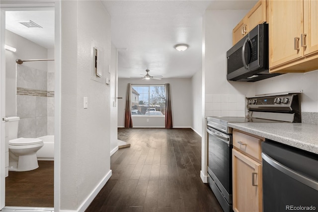 kitchen featuring light countertops, visible vents, stainless steel appliances, dark wood finished floors, and light brown cabinets