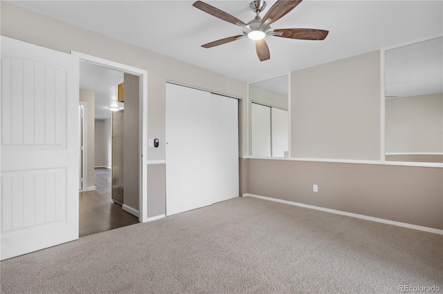 unfurnished bedroom with a closet, carpet floors, ceiling fan, and baseboards