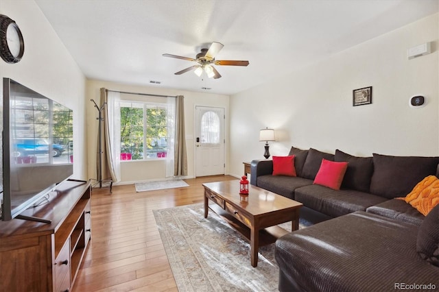 living room with ceiling fan and light hardwood / wood-style floors