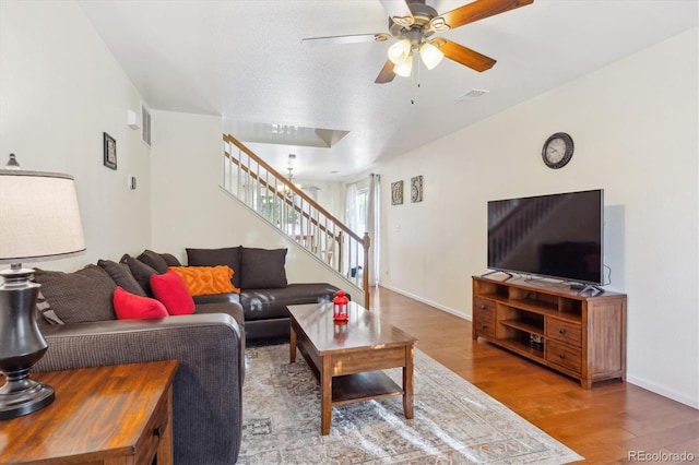 living room featuring ceiling fan and hardwood / wood-style floors