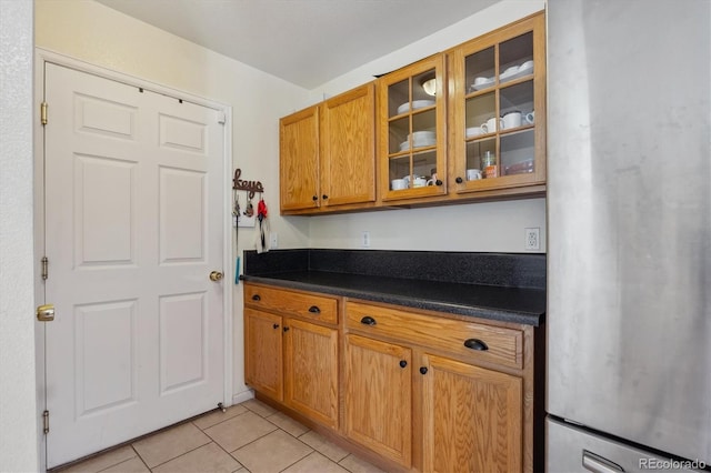 kitchen with stainless steel fridge and light tile patterned floors