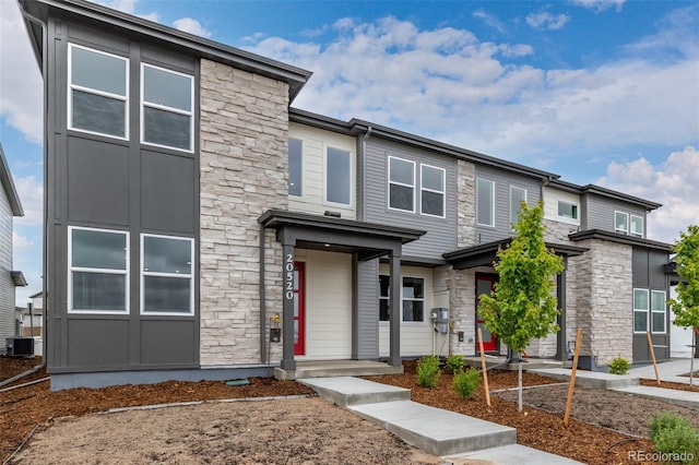 20520 E 58th Ave, Aurora, CO 80019 - view of front of property featuring stone siding and cooling unit