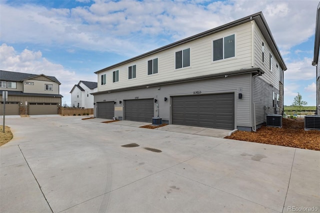20520 E 58th Ave, Aurora, CO 80019 - view of front facade featuring central AC, an attached garage, and concrete driveway
