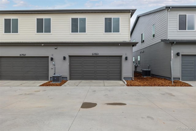 20520 E 58th Ave, Aurora, CO 80019 - view of front facade with central AC, an attached garage, and driveway