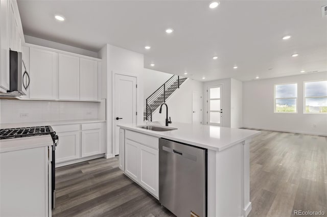 20520 E 58th Ave, Aurora, CO 80019 - kitchen featuring stainless steel appliances, a sink, wood finished floors, healthy amount of natural light, and recessed lighting