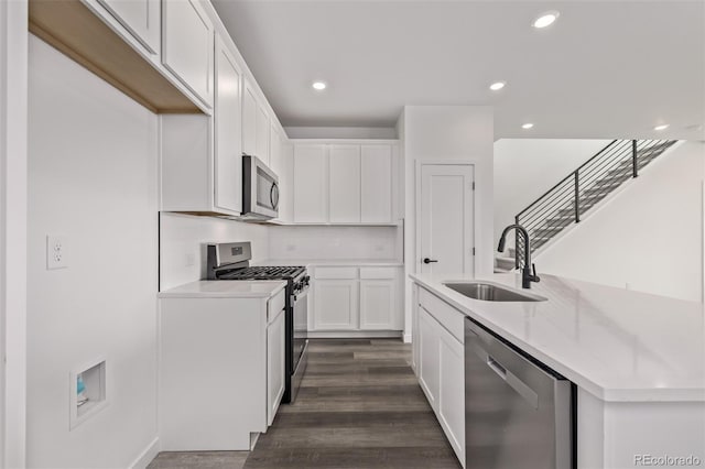 20520 E 58th Ave, Aurora, CO 80019 - kitchen featuring a sink, appliances with stainless steel finishes, white cabinets, light countertops, and recessed lighting