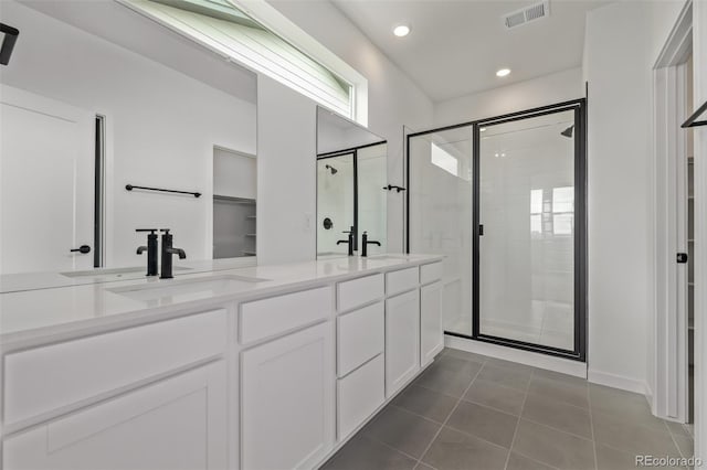 20520 E 58th Ave, Aurora, CO 80019 - bathroom with a stall shower, double vanity, tile patterned floors, recessed lighting, and a spacious closet