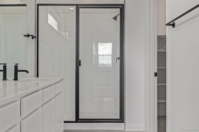 20520 E 58th Ave, Aurora, CO 80019 - full bathroom with a shower stall, a walk in closet, and vanity