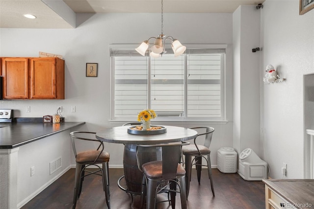 dining room with dark wood-type flooring and a chandelier