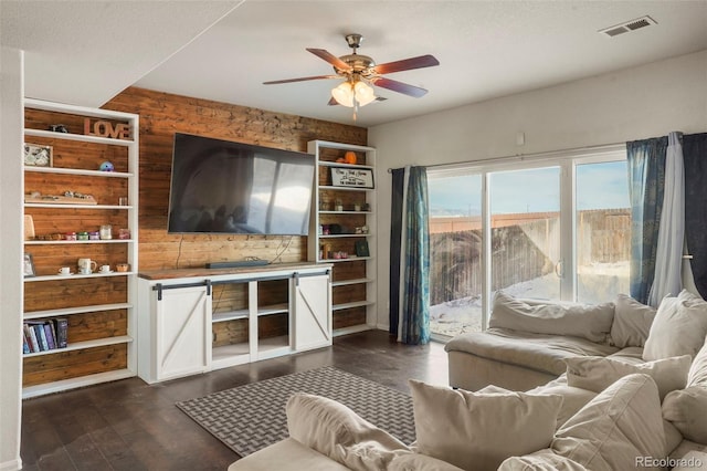 living room with dark hardwood / wood-style flooring and ceiling fan