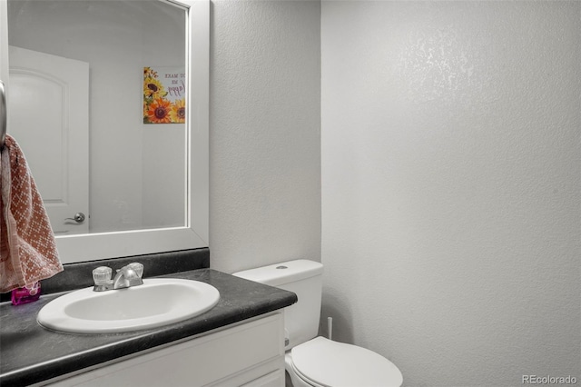 bathroom featuring vanity and toilet