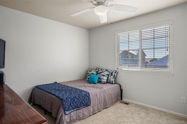 bedroom with light colored carpet and ceiling fan