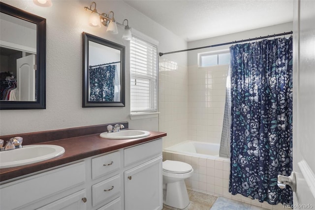 full bathroom featuring vanity, shower / bath combo, a textured ceiling, and toilet