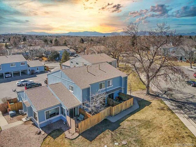 aerial view at dusk with a mountain view and a residential view