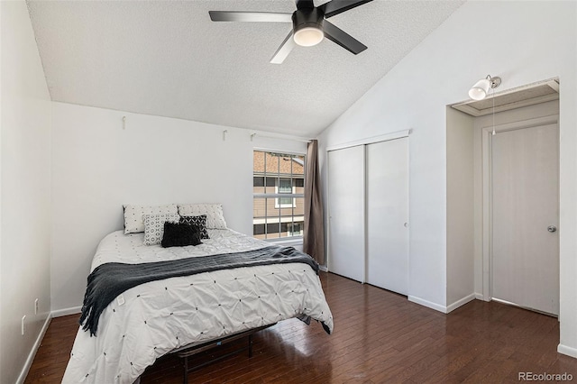 bedroom with a closet, vaulted ceiling, ceiling fan, and dark hardwood / wood-style floors