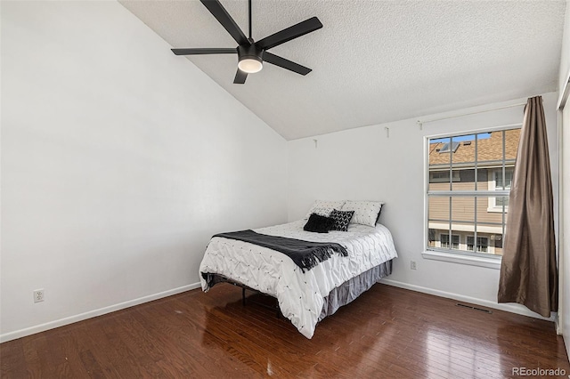 bedroom featuring a textured ceiling, ceiling fan, dark wood-type flooring, and vaulted ceiling