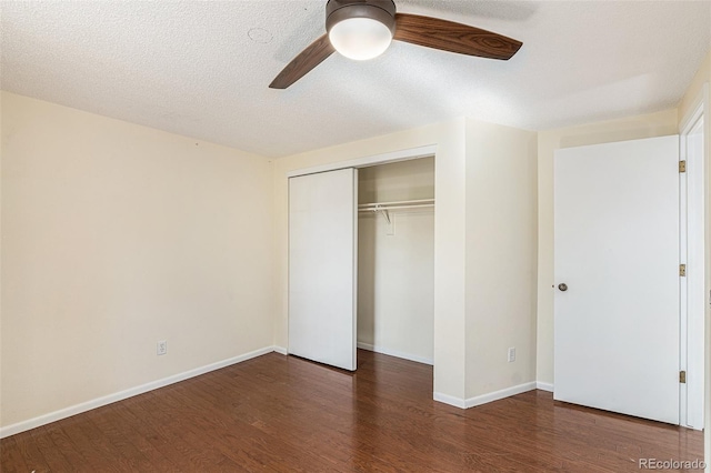 unfurnished bedroom with ceiling fan, dark hardwood / wood-style flooring, a textured ceiling, and a closet