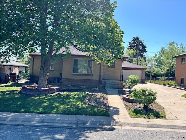 2124 S Yates St, Denver, CO 80219 - view of front of house featuring brick siding and driveway