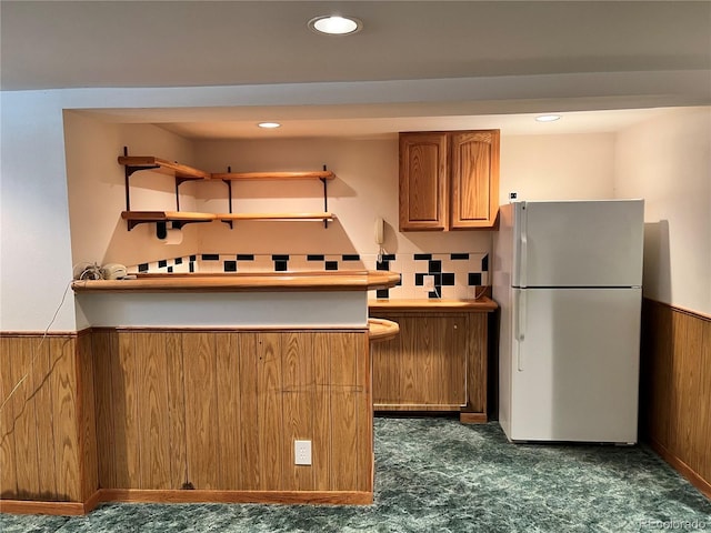 2124 S Yates St, Denver, CO 80219 - kitchen featuring freestanding refrigerator, dark colored carpet, brown cabinetry, wainscoting, and recessed lighting