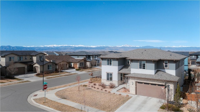 view of front of property featuring a mountain view and a residential view