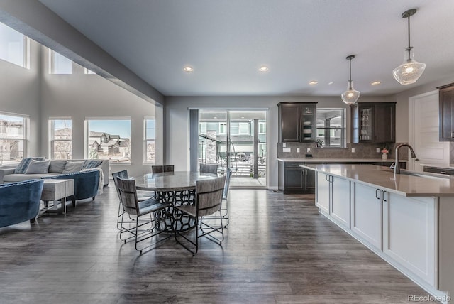 dining area featuring dark wood-type flooring and recessed lighting