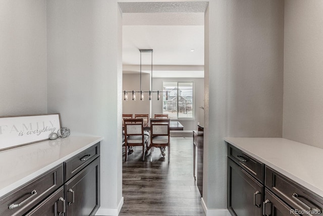 interior space featuring dark wood-type flooring and baseboards