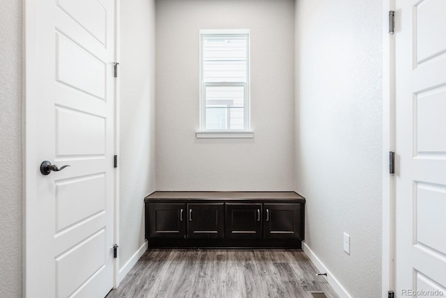 interior space featuring light wood-type flooring and baseboards