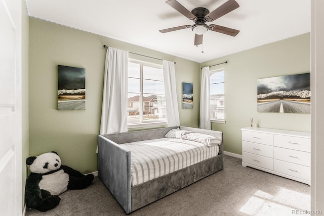 carpeted bedroom with a ceiling fan and baseboards