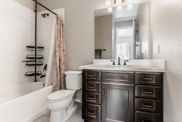 full bath featuring vanity, toilet, shower / bath combo with shower curtain, and a textured wall