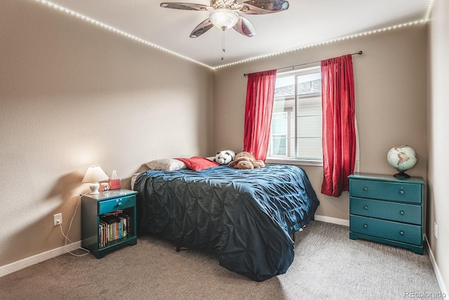 carpeted bedroom featuring baseboards and a ceiling fan