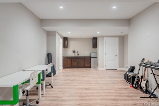 office with recessed lighting, light wood-style flooring, baseboards, and a sink