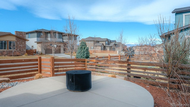 view of patio / terrace featuring fence and a residential view