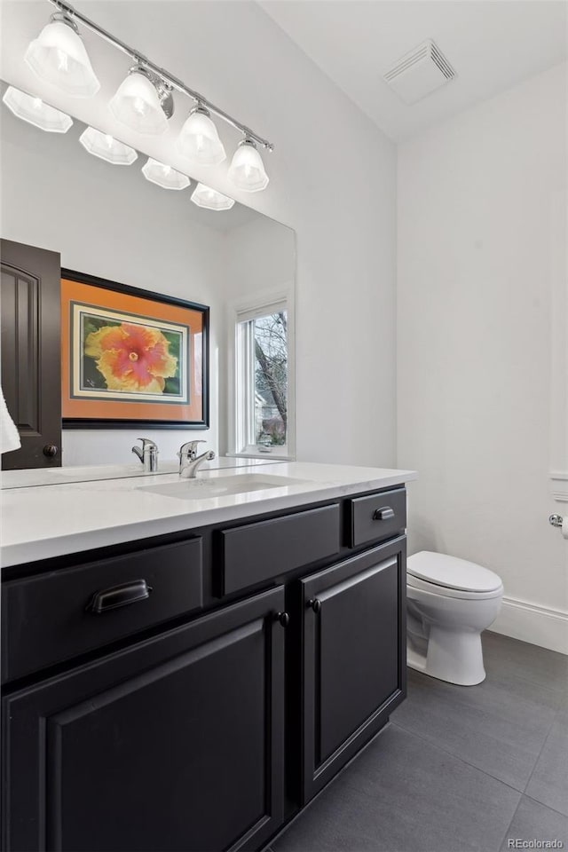 bathroom with tile patterned floors, vanity, and toilet