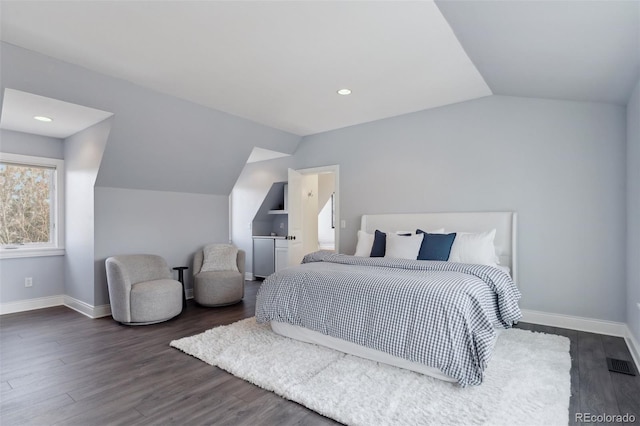 bedroom with dark wood-type flooring and lofted ceiling