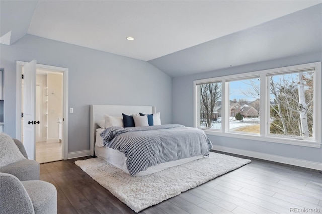 bedroom with dark hardwood / wood-style flooring and vaulted ceiling