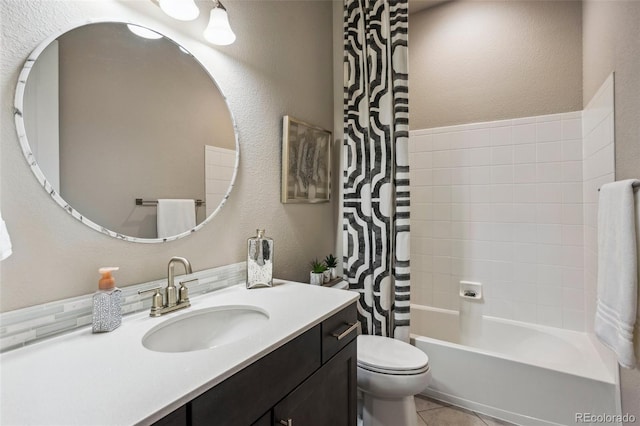 bathroom with a textured wall, toilet, vanity, and shower / bath combination with curtain